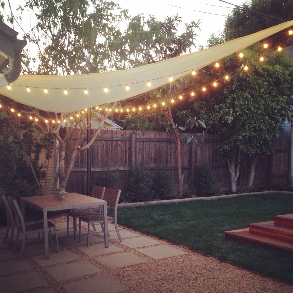 After- shade sail and string lights under dining area Yelp
