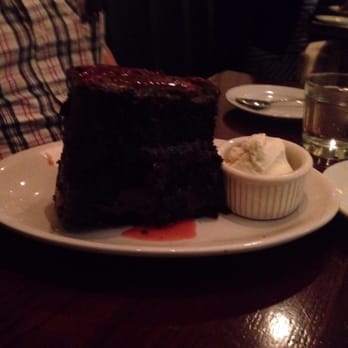 Chicago Q - Chicago, IL, United States. Chocolate cake with chocolate icing with a light cherry sauce drizzle paired with vanilla ice cream. OMG!