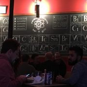 Photo of Miracle of Science Bar + Grill - Cambridge, MA, United States. The menu is on the wall which would be cool if they had table menus. Can be tough to read if your sitting the far away or visually impaired