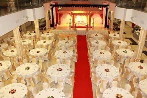 typical seating arrangement and podium for a hindu wedding reception