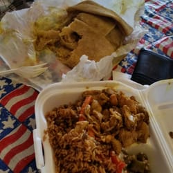 Photo of Singhs Fast Food - Christiansted, Virgin Islands, U.S. Virgin Islands. Shrimp and conch roti + boneless chicken dinner plate with seasoned rice