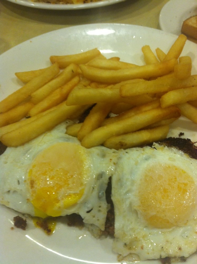 Corned Beef Hash with Eggs Over Easy and Fries Cooked to Perfection