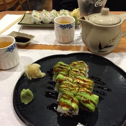 Photo of Moshi Moshi Japanese Sushi Bar & Restaurant - Davis, CA, United States. Green dragon roll, tea, and California roll