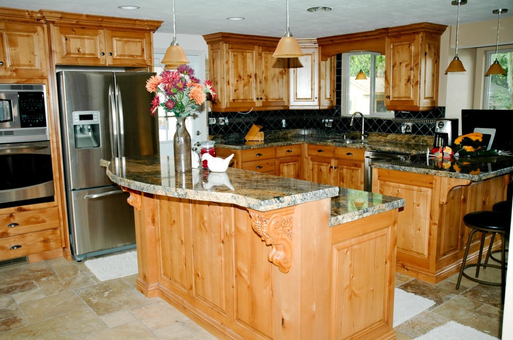 knotty alder with glaze kitchen - carved corbels to support granite