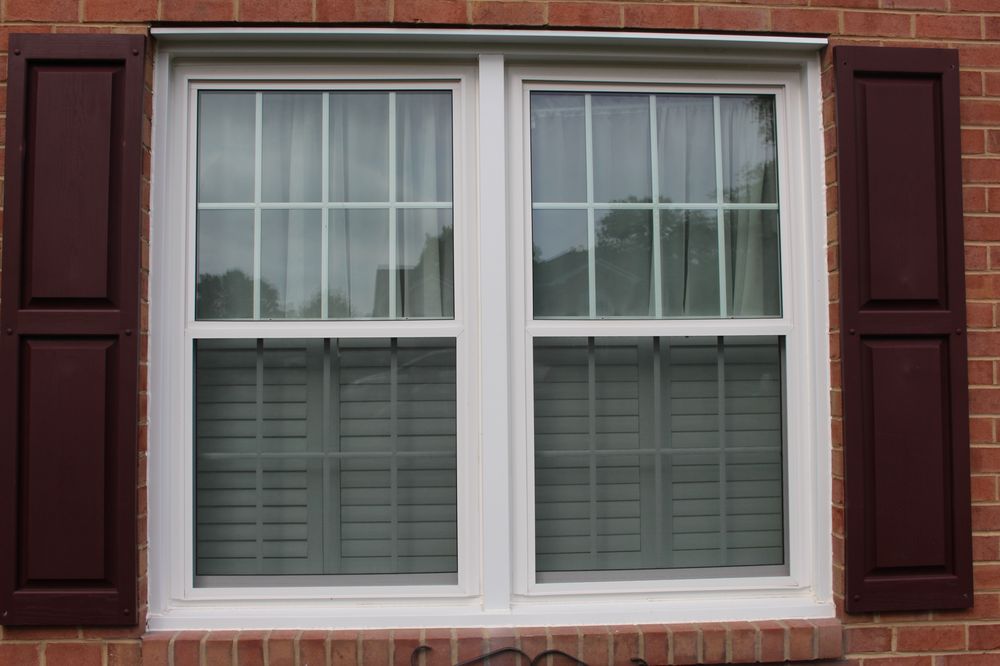 White double hung window on a red brick house - Yelp