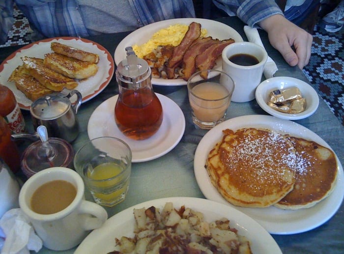 top "The Open Road" w/ french toast, scrambled eggs, bacon, fresh